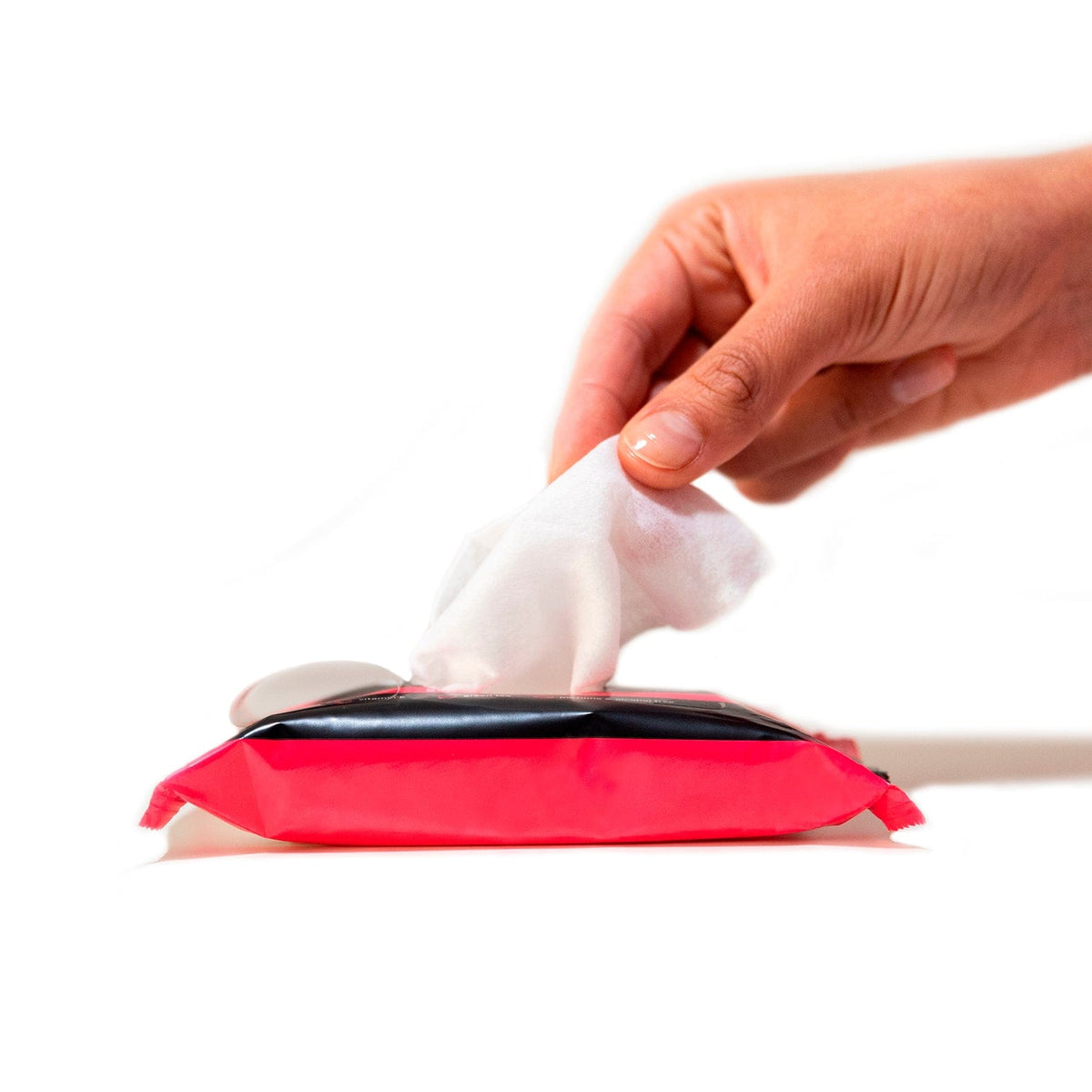 Hand taking a single wipe out of the package